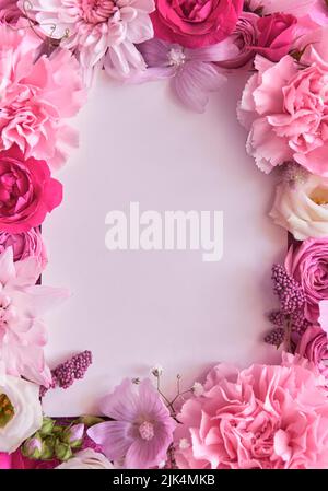 Pink flowers frame white mockup background. Flat lay, top view, copy space Stock Photo