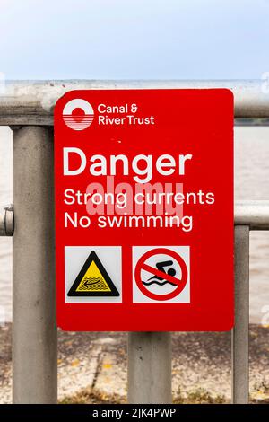 canal & river trust Danger sign stating strong currents no swimming Stock Photo