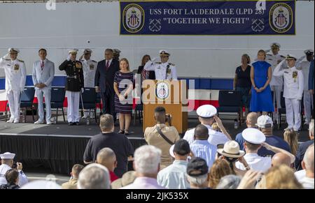 Fort Lauderdale, Florida, USA. 30th July, 2022. The playing of the National Anthem as guests stand at the beginning of the commissioning ceremony for the USS Fort Lauderdale (LPD 28), Port Everglades, Florida.The USS Fort Lauderdale (LPC28) is a San Antonio-class amphibious transport dock ship. LPDs are used to transport and land Marines, their equipment, and supplies by embarked Landing Craft Air Cushion (LCAC) or conventional landing craft and amphibious assault vehicles (AAV) augmented by helicopters or vertical take-off and landing aircraft (MV 22). Credit: UPI/Alamy Live News Stock Photo