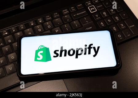 Shopify logo on smartphone screen  , background is a keyboard  , Sydney Australia July 30 2022 Stock Photo