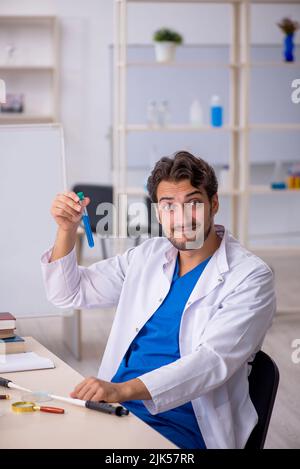 Young chemist working at the lab Stock Photo