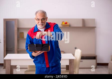 Old carpenter working at home Stock Photo