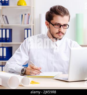 The young male architect working in the office Stock Photo