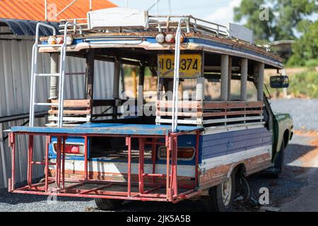 Old Thai pickup truck minibus conversion with colorful, rickety, wooden passenger compartment Stock Photo