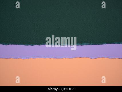 Dark green, teal matte paper, pastel light purple and old rose brown colors paper abstract background. Stock Photo