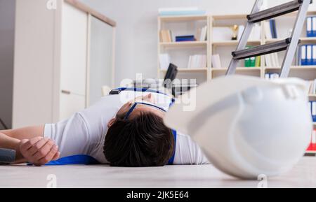 The worker after falling from height - unsafe behavior Stock Photo