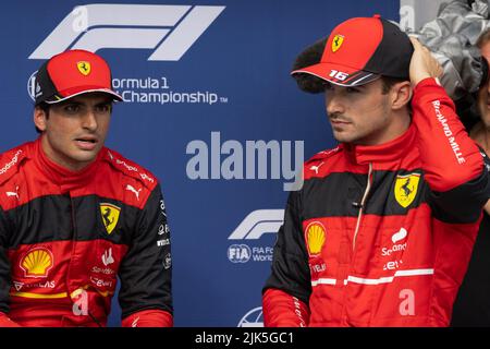 Mogyorod. 30th July, 2022. Third placing Ferrari's Monegasque driver Charles Leclerc (R) and second placing Ferrari's Spanish driver Carlos Sainz (L) prepare to celebrate their victory after the F1 Hungarian Grand Prix Qualifying at Hungaroring in Mogyorod, Hungary on July 30, 2022. Credit: Attila Volgyi/Xinhua/Alamy Live News Stock Photo