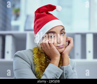 Depression is an illness. Portrait of a sad young woman lost in thought at her desk in the office. Stock Photo