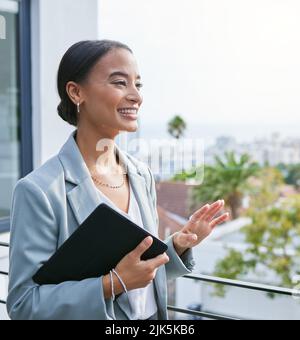 A realtor that listens to your needs. a young female real estate agent showing a client a house. Stock Photo