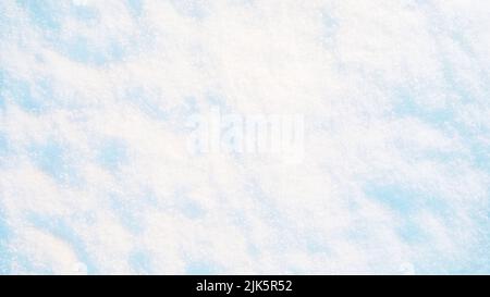White snow texture in sunlight. Bright Christmas background Stock Photo