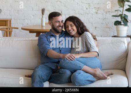 Cheerful dating couple in love enjoying being at home together Stock Photo