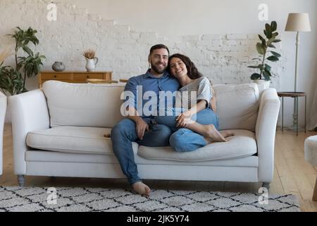 Happy young adult married couple home full length portrait Stock Photo