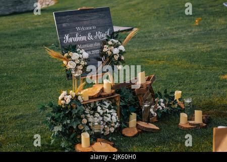 Wedding. Wedding ceremony. Arch. Arch, decorated with pink and white flowers standing in the woods, in the wedding ceremony area Stock Photo