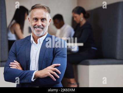 Ive experienced a lot in this business. a mature businessman working from a cafe. Stock Photo
