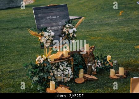 Wedding. Wedding ceremony. Arch. Arch, decorated with pink and white flowers standing in the woods, in the wedding ceremony area Stock Photo