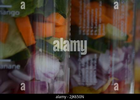 Three glass jars with layering various vegan salads for healthy lunch. The concept of fitness and vegetarian food. Stock Photo