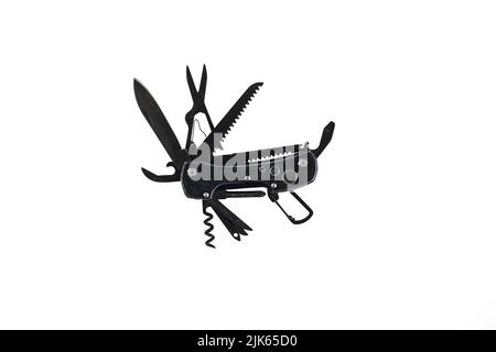 a  black metallic multitool  expanded and isolated on white Stock Photo