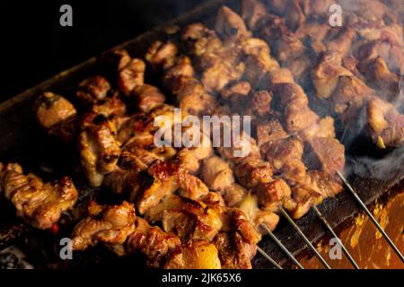 sate klatak or sate kambing or satay goat, lamb, Lamb or meat goat satay with charcoal ingredient on red fire grilling by people, Indonesia cooking sa Stock Photo