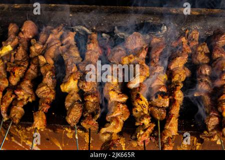 sate klatak or sate kambing or satay goat, lamb, Lamb or meat goat satay with charcoal ingredient on red fire grilling by people, Indonesia cooking sa Stock Photo