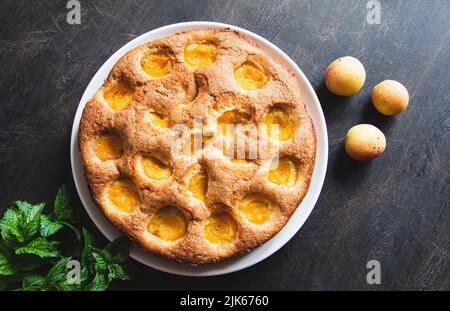 cake with apricots. Homemade delicious apricot cake with fresh apricots. Stock Photo