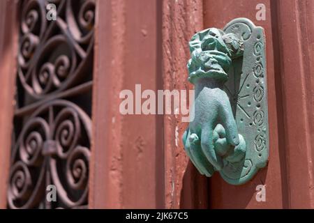 Traditional old door knocker shaped like womans hand Stock Photo