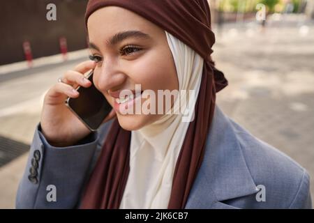 Arab woman in headscarf talking on the phone Stock Photo