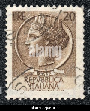 A stamp printed in Italy shows  Woman head, Italian Republic, dark brown, 20 Lire, circa 1980 Stock Photo