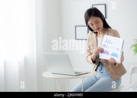 Young asian business woman using laptop computer for video conference online, businesswoman working with video call for meeting and showing graph repo Stock Photo