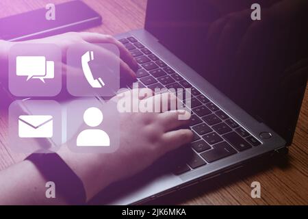 Businesswoman using laptop with hologram icons. Contact us or Customer support hotline people connect. Internet of things. Stock Photo