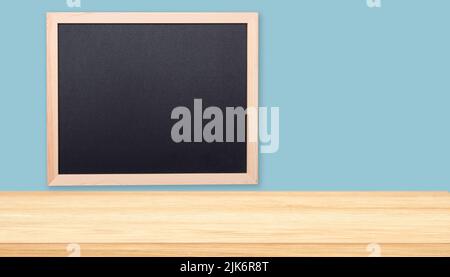Minimal office or classroom interior with tabletop, desk and black board Stock Photo