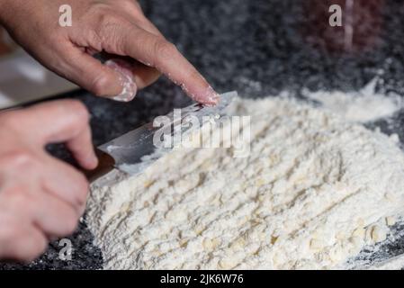 woman mixing flour with butter to prepare a cake Stock Photo