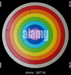 A rainbow puzzle for toddlers on a black background Stock Photo