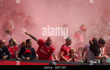 Manchester United fans react after Rayo Vallecano fans let off a smoke