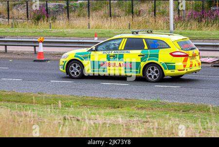 A Scot Medical Independent Ambulance Service car motoring along the Kingsway West Dual Carriageway in Dundee, UK Stock Photo