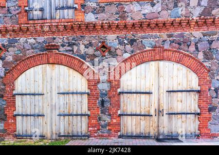 stone masonry house with two wooden doors Stock Photo