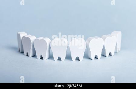 Toy teeth row on blue background. High quality photo Stock Photo