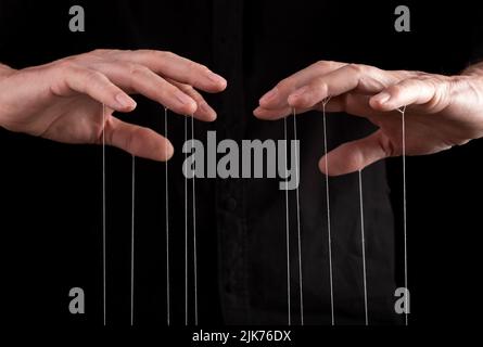 Hand manipulating and controlling smth with strings concept. High quality photo Stock Photo