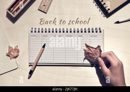 Back to school words, text on notebook. Low impact school supplies. Study stationary, week planner, pencils, notebook Stock Photo