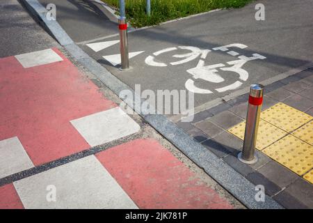 pedestrian crossing with teeth and red markings for the movement of bicycles on the roadway Stock Photo