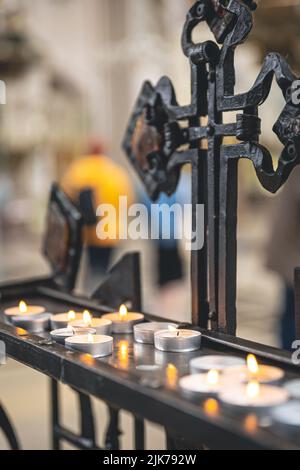 Lots of small candles in a catholic church. Stock Photo
