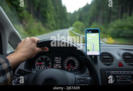 Navigator in the car on the road in a forest area, close-up. Stock Photo
