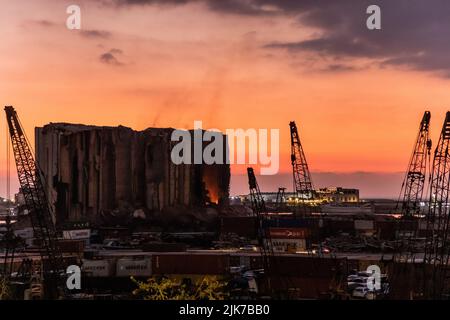 BEIRUT, LEBANON - JULY 31, 2022: View of burning Beirut port grain silos after their partial collapse on July 31, 2022. Stock Photo