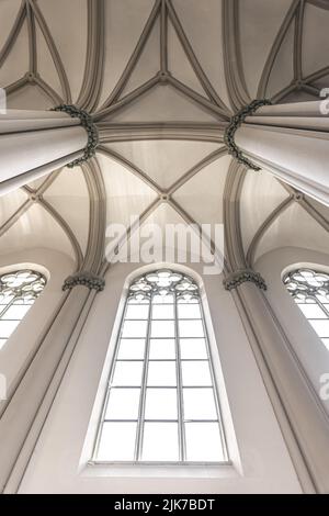 Bright interior of the church with stained-glass windows, view from below. Stock Photo