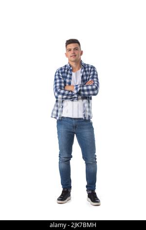 Full length portrait of young man standing with arms crossed isolated over white background Stock Photo