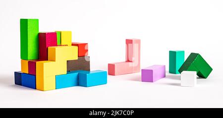 Colorful wooden elements of tetris puzzle. Construction, formation concept. Kids logical game for problem solving skills development. High quality photo Stock Photo