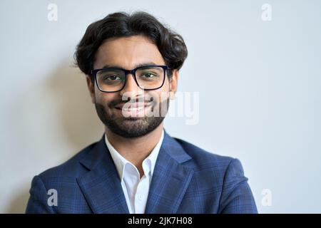 Happy young indian business man wearing suit and glasses. Headshot portrait Stock Photo