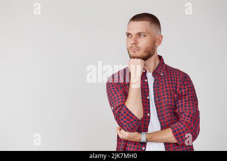 man holding arms folded, touching chin with hand Stock Photo