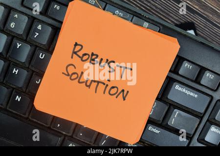 Concept of Robust Solution write on sticky notes isolated on Wooden Table. Stock Photo