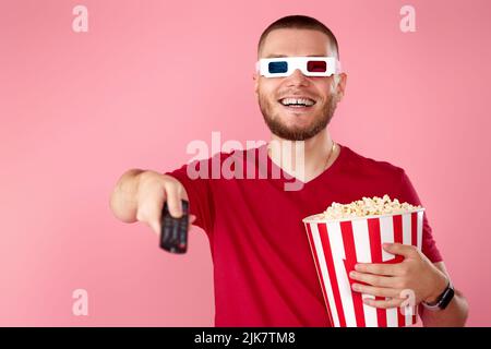 man in 3d glasses using console watching movie Stock Photo