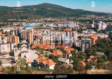 Looking out over the city of Mitrovica, Kosovo, from Miner's Hill. The Serbian Orthodox Church of St. Dimitrije is in the foreground Stock Photo